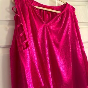 Pink shirt feels like silk has a print pattern of leopard with slotted sleeves.